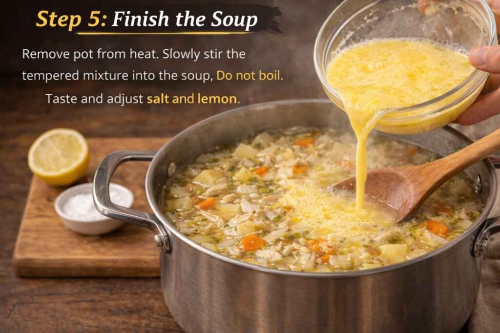 Stirring egg and lemon mixture into chicken potato avgolemono soup to finish the soup