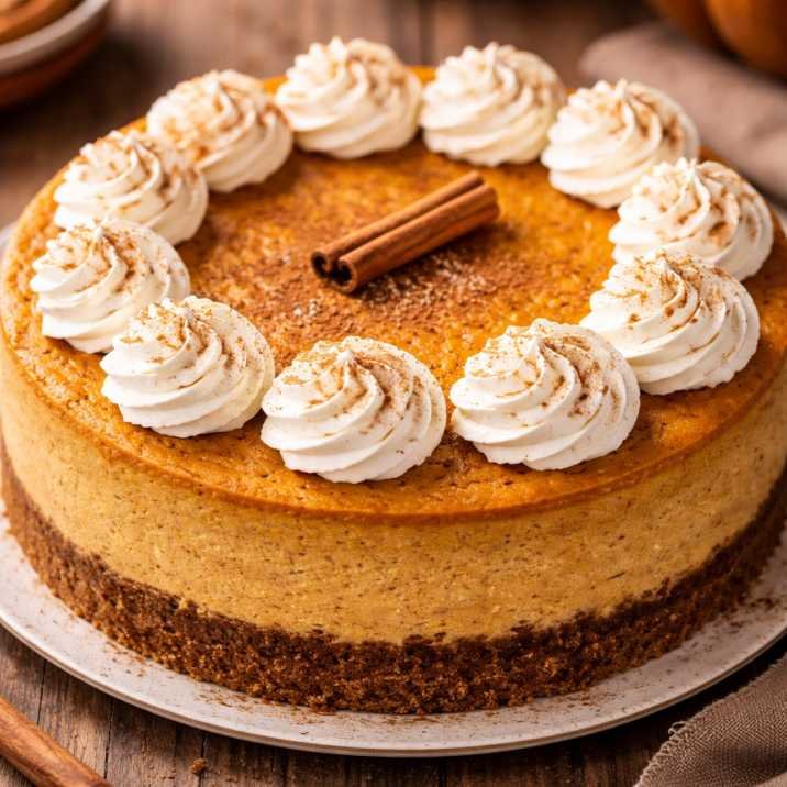 Creamy pumpkin cheesecake with graham cracker crust and whipped cream topping styled like Costco pumpkin cheesecake