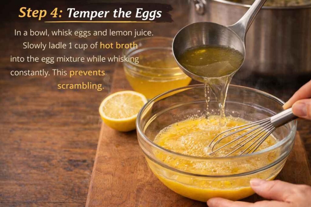 Tempering eggs with hot broth and lemon juice for chicken potato avgolemono soup