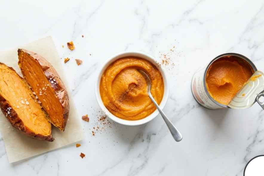 Sweet Potato Brownies (Fudgy, Flourless & Better Than You'd Expect) 4 Fresh roasted sweet potato next to an open can of sweet potato puree with a small bowl of smooth puree in the center