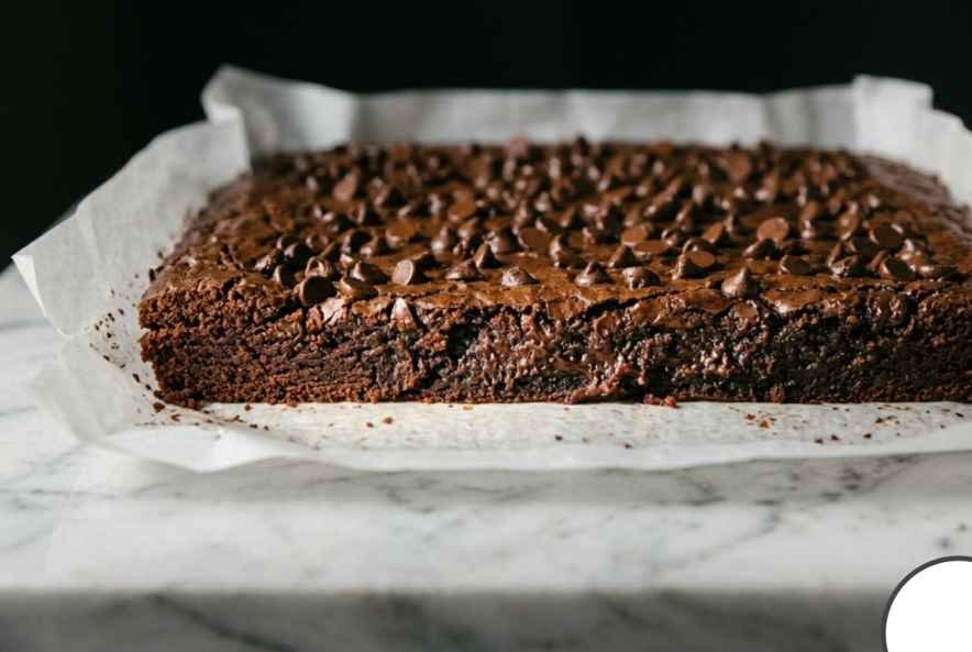 Sweet Potato Brownies (Fudgy, Flourless & Better Than You'd Expect) 11 Side view of baked sweet potato brownies in pan showing firm set edges against a slightly soft gooey center