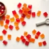 cannabutter hard candy recipe, hard candy pieces on white marble with candy thermometer