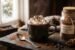 Creamy homemade hot chocolate with marshmallows beside a jar of homemade hot chocolate powder on a rustic wooden table