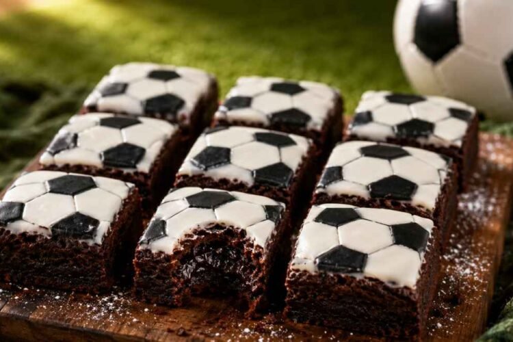 Little Debbie soccer-themed brownies recipe with fudgy chocolate interior, white vanilla icing, and black soccer ball decoration on a rustic wooden board